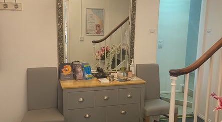 Entrance of Hude in Royal Tunbridge Wells, England, GB featuring a stylish dresser and decorative items.