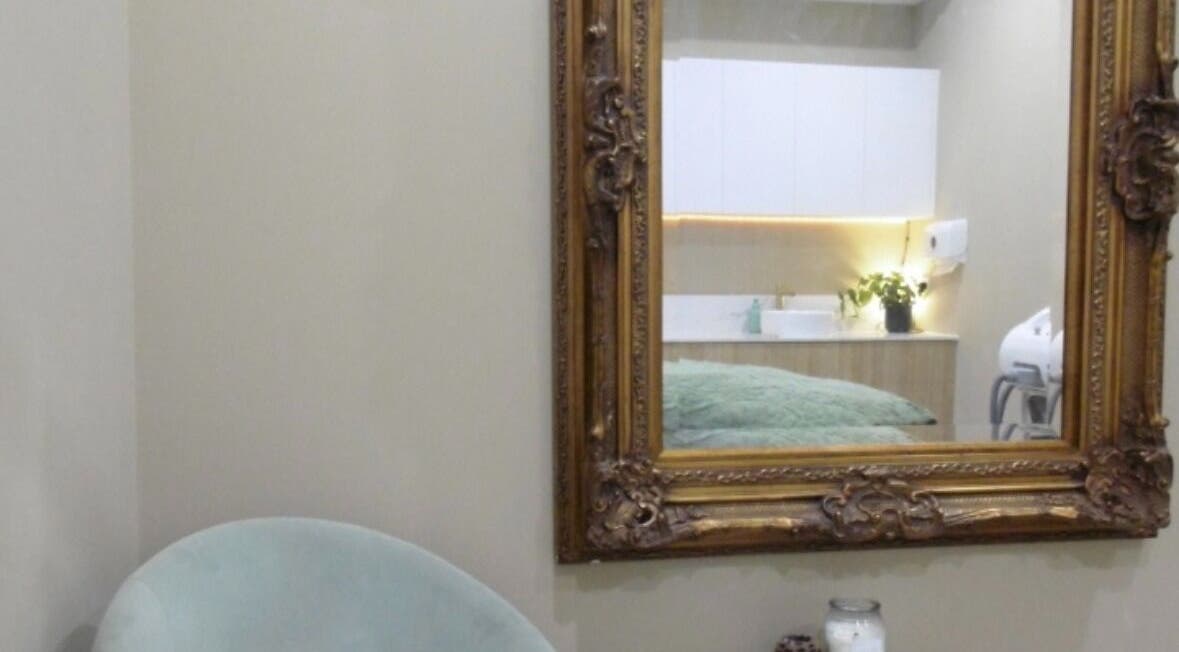An ornate mirror and cozy chair at Timeless Aesthetics in Karnup, Western Australia, AU.