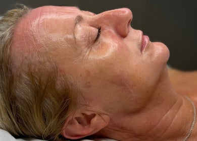 Woman enjoying facial treatment at The Skin Theory, Lichfield, England, GB; serene and rejuvenating spa experience.