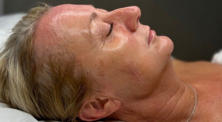 Woman enjoying facial treatment at The Skin Theory, Lichfield, England, GB; serene and rejuvenating spa experience.