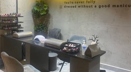 Modern manicure station at 5ive Seconds Salon - Al Raed, Riyadh, Riyadh Province, SA, with polishes and greenery.