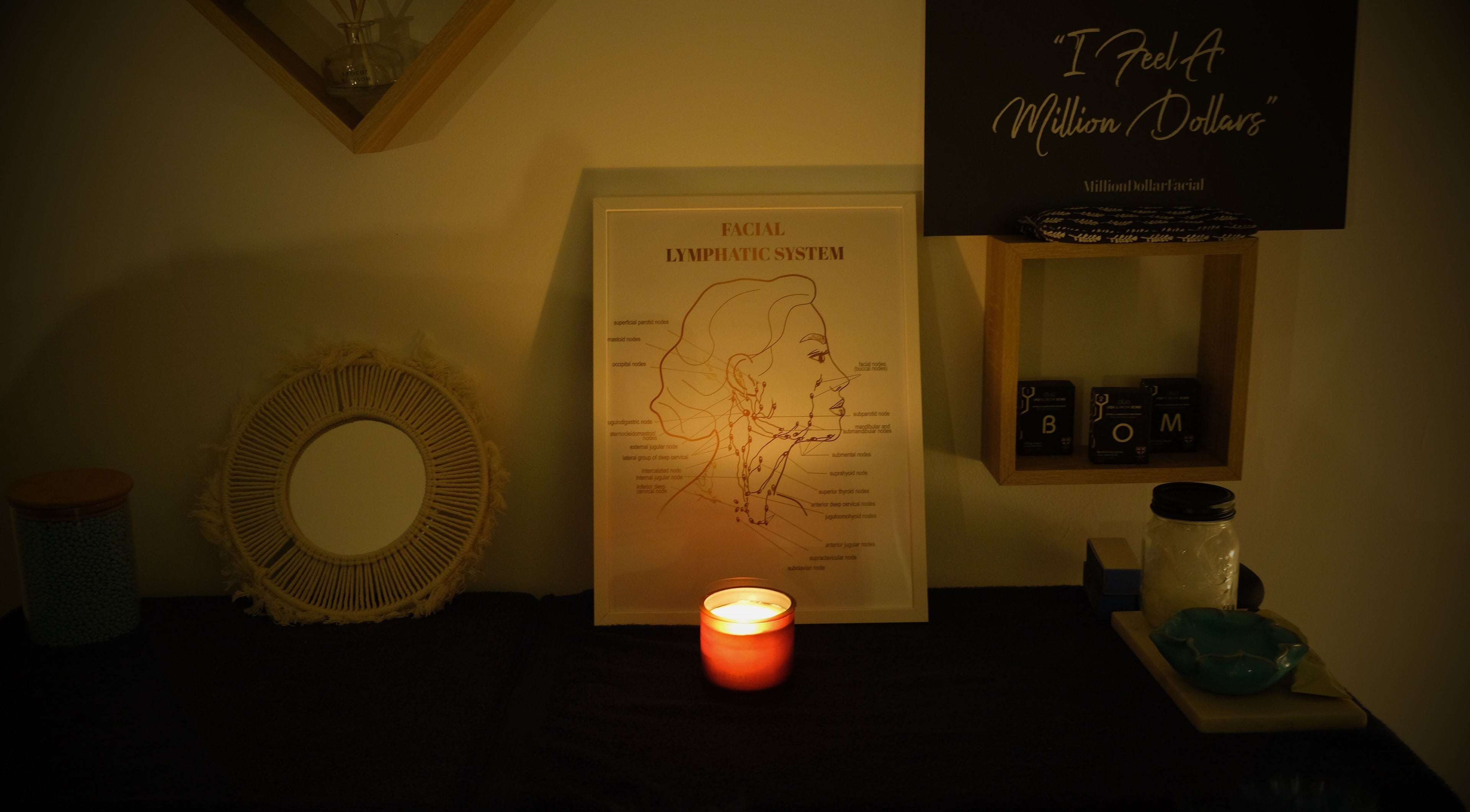 Ambient setting with candle and facial anatomy at Lilybella Beauty, Chudleigh, England, GB. Cozy and inviting.