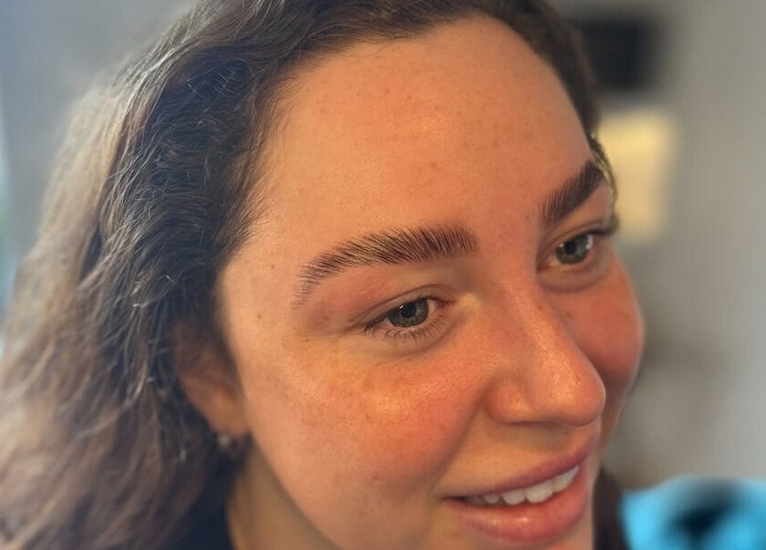 Client showcasing expertly shaped brows at Lilybella Beauty in Chudleigh, England, GB.