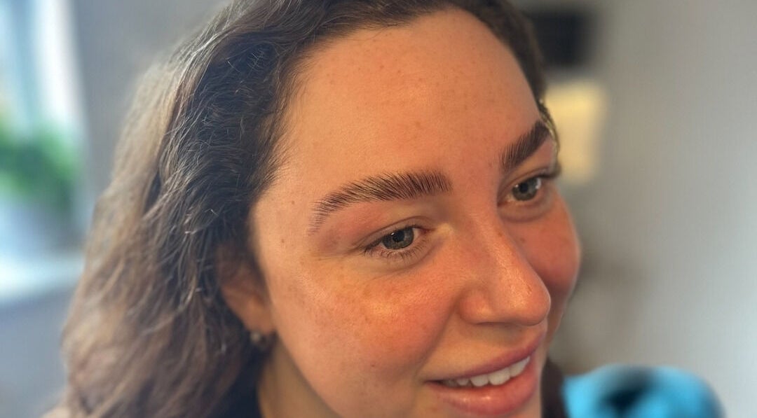 Client showcasing expertly shaped brows at Lilybella Beauty in Chudleigh, England, GB.