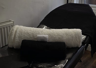 Luxurious treatment bed with plush towels at By Tuesday Skin Studio, Eccles, England, GB.