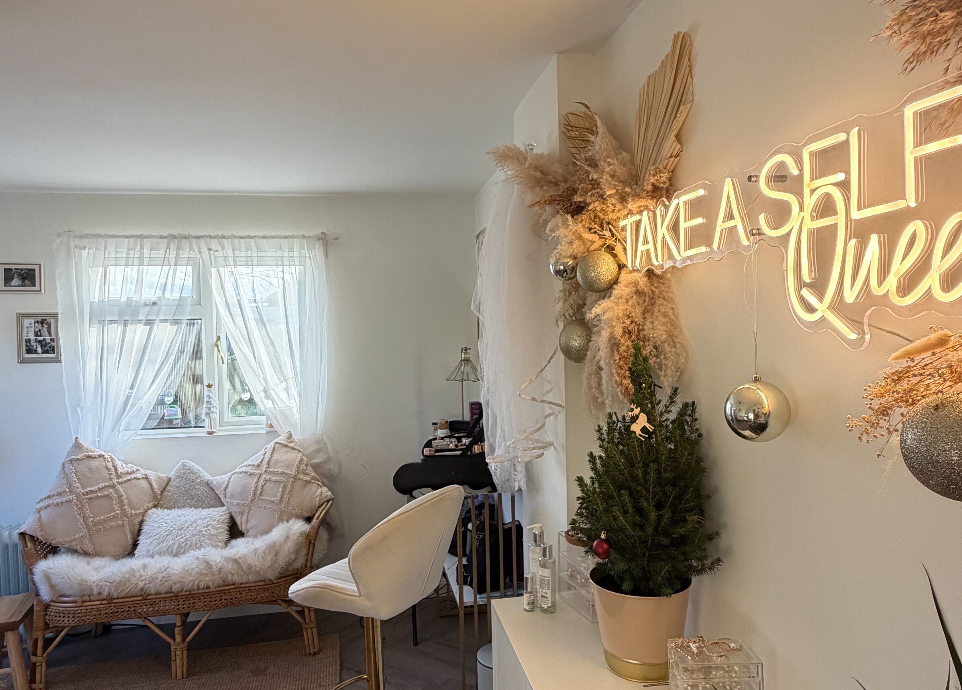 Celfie Bridal Hair and Makeup, Midsomer Norton, features a cozy, glamorous interior with neon sign and plush seating.