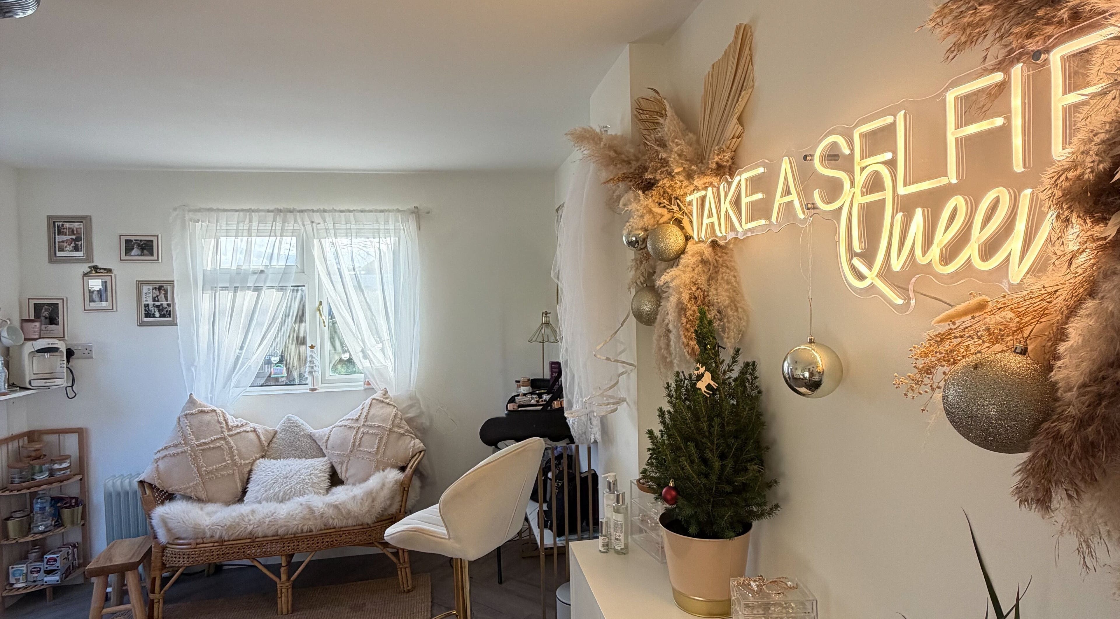 Celfie Bridal Hair and Makeup, Midsomer Norton, features a cozy, glamorous interior with neon sign and plush seating.