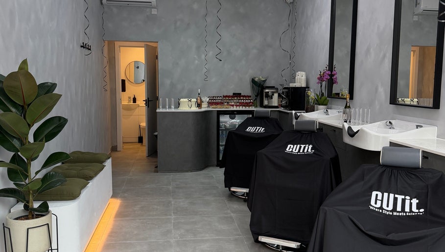 Elegant salon interior at CUTit. in Beckenham, England, GB, with chic decor and modern furnishings.