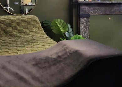 Relaxing lounge area at LashesbyEmma, featuring soft greenery and elegant decor in Manchester, England, GB.