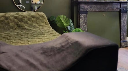 Relaxing lounge area at LashesbyEmma, featuring soft greenery and elegant decor in Manchester, England, GB.