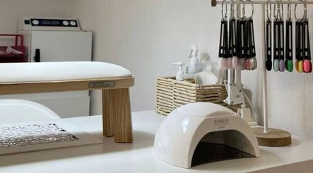 Nail station at Nailed.By.Penny, Boksburg, Gauteng, ZA, showcasing polishes and a UV lamp.