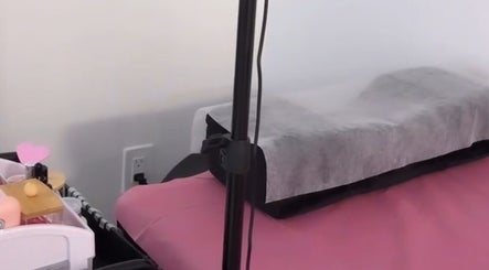 Treatment bed setup at Lash&Brow Glow, Toronto, Ontario, CA, featuring soft pink linens.