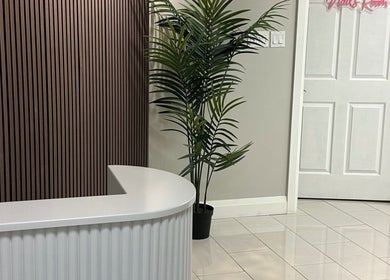Elegant reception area at 92 Lakeshore Road East, Mississauga, Ontario, CA with a sleek white desk and plant.