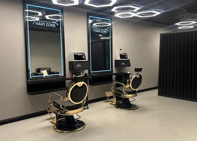 Modern interior of Hair Zone - An Narjis in Riyadh. Sleek salon chairs and mirrors reflect a stylish ambiance.