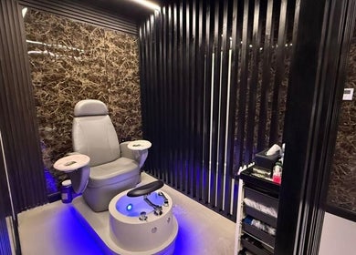 Luxurious pedicure chair at Hair Zone - Al Yasmin, Riyadh, Riyadh Province, SA with sleek black marble walls.