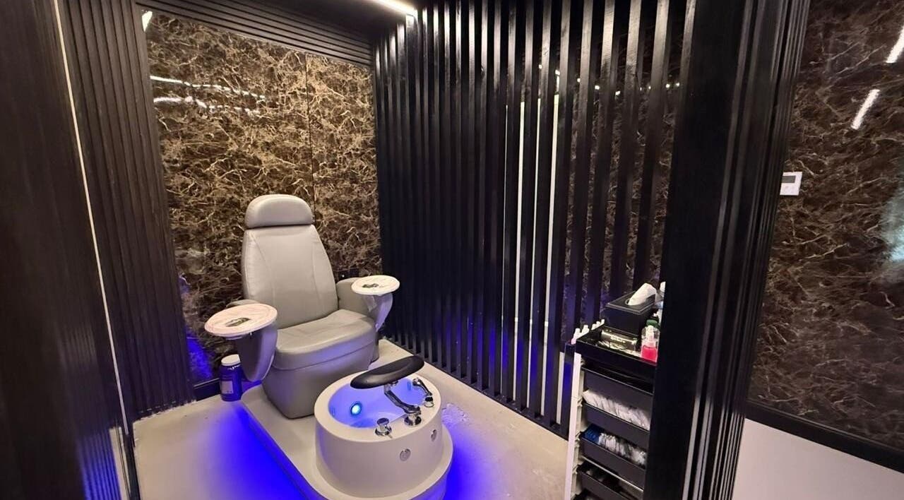 Luxurious pedicure chair at Hair Zone - Al Yasmin, Riyadh, Riyadh Province, SA with sleek black marble walls.