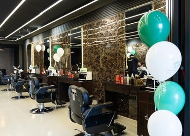 Modern styling chairs at Hair Zone - Al Yasmin, Riyadh, Riyadh Province, SA with elegant mirrors and balloons.
