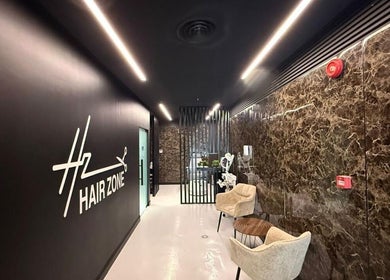 Modern entrance at Hair Zone - Al Yasmin, Riyadh, Riyadh Province, SA showing sleek design and seating area.