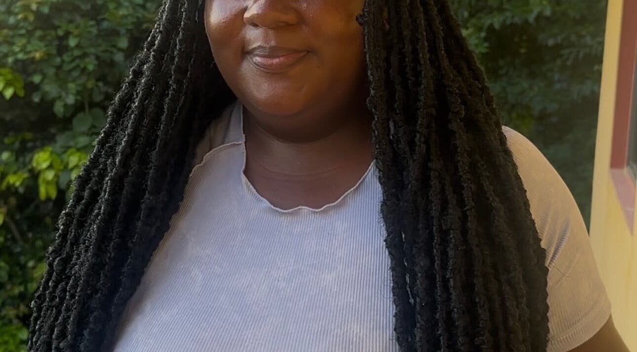 Model with long fauxlocs at fauxlocs.by.niahh, Arnos Vale, St. George, VC, showcasing natural style.