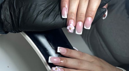 Elegant pink and white nail design with floral accents at T Tips And Toes, St Albans, England, GB.
