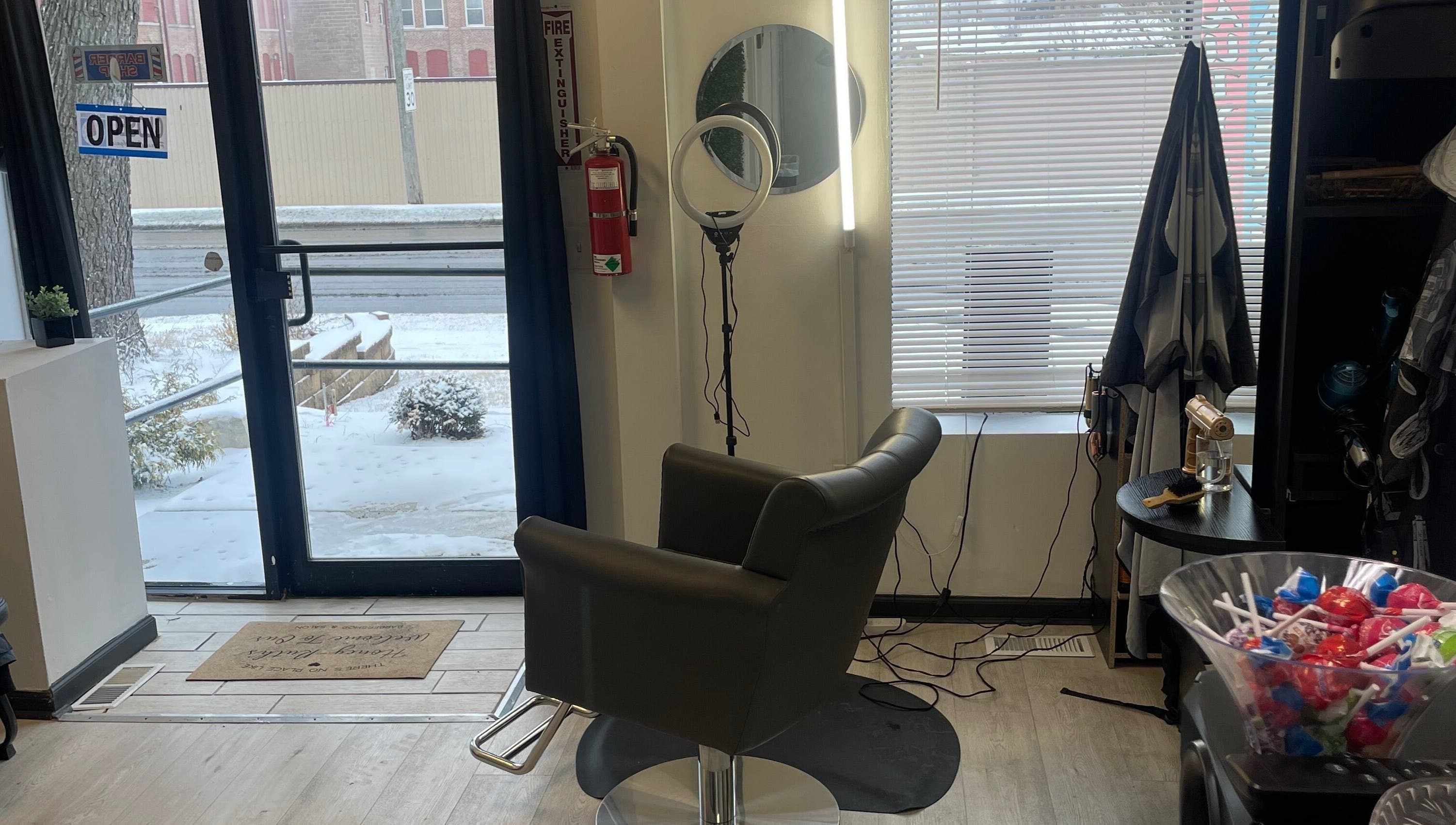 Savage Kutz salon's stylish chair near entrance in Aurora, Illinois, US, with vibrant decor.