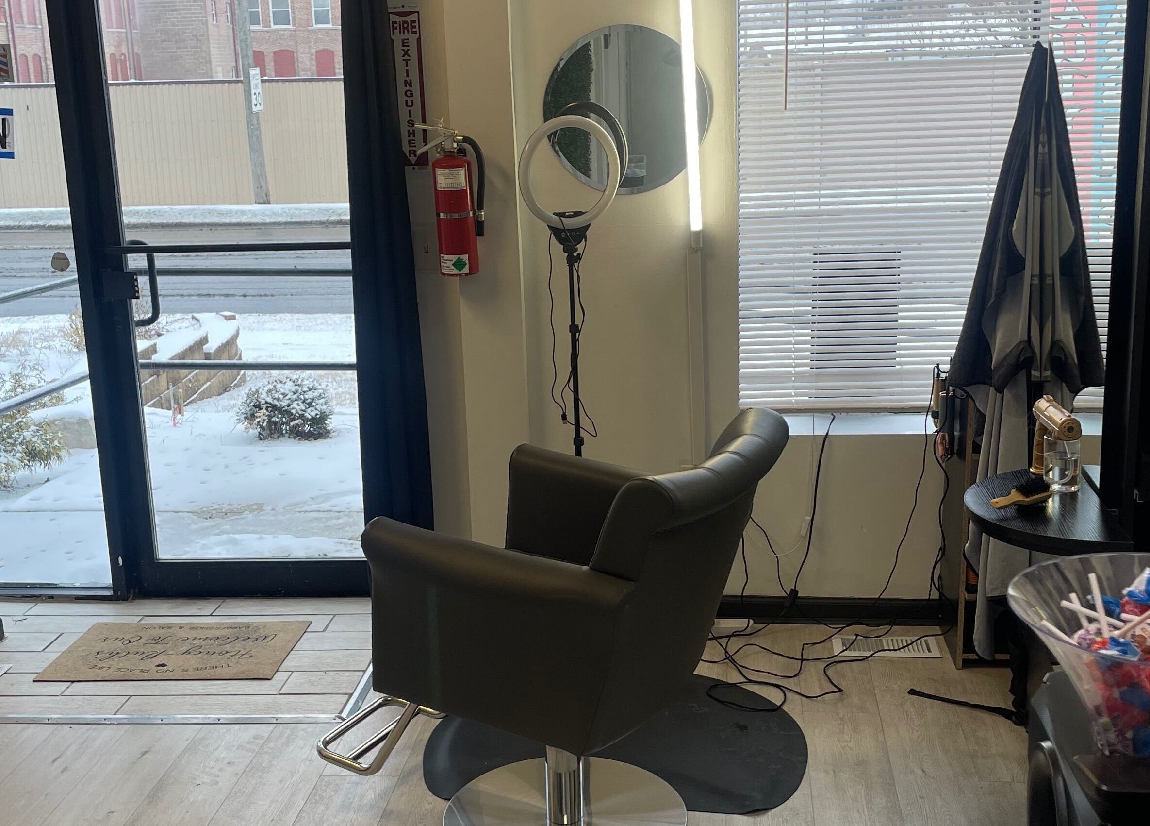 Savage Kutz salon's stylish chair near entrance in Aurora, Illinois, US, with vibrant decor.