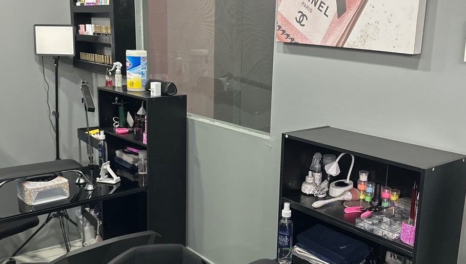 Interior of Kimmi’s Luxe Lounge in San Juan, showcasing organized beauty tools and products on sleek black shelves.