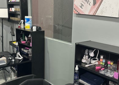 Interior of Kimmi’s Luxe Lounge in San Juan, showcasing organized beauty tools and products on sleek black shelves.