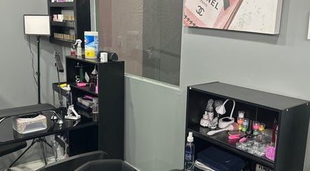 Interior of Kimmi’s Luxe Lounge in San Juan, showcasing organized beauty tools and products on sleek black shelves.