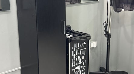Hair styling station at Kimmi’s Luxe Lounge in San Juan, featuring modern appliances and sleek black design.