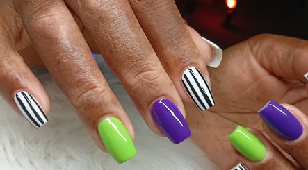 Close-up of colorful nail art at Cialeyah Beauty Bar, Philipsburg, SX showcasing vibrant stripes and polish.