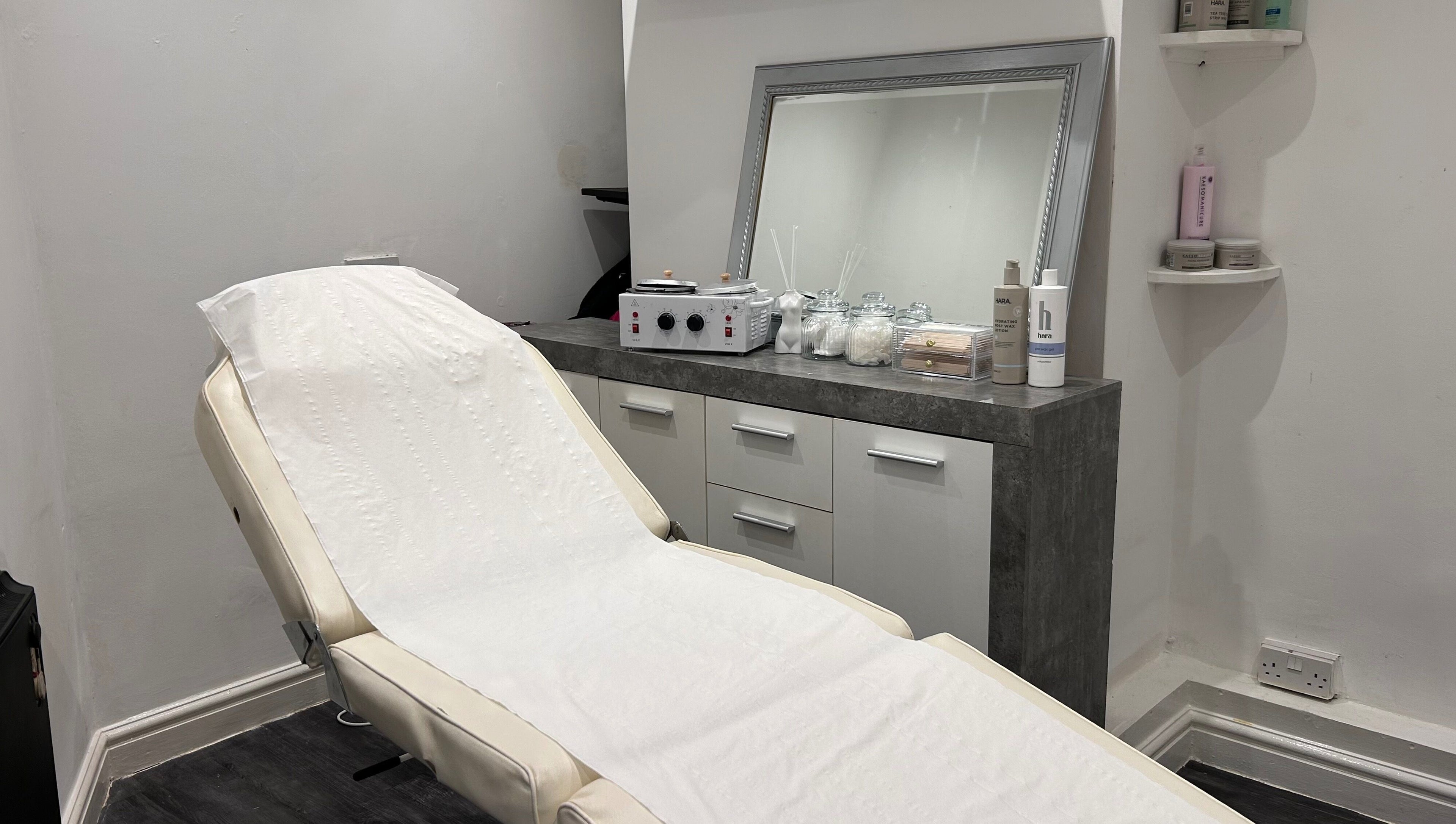 A tranquil treatment room at Beautiful You, Birmingham, England, GB, featuring a plush reclining chair and elegant decor.