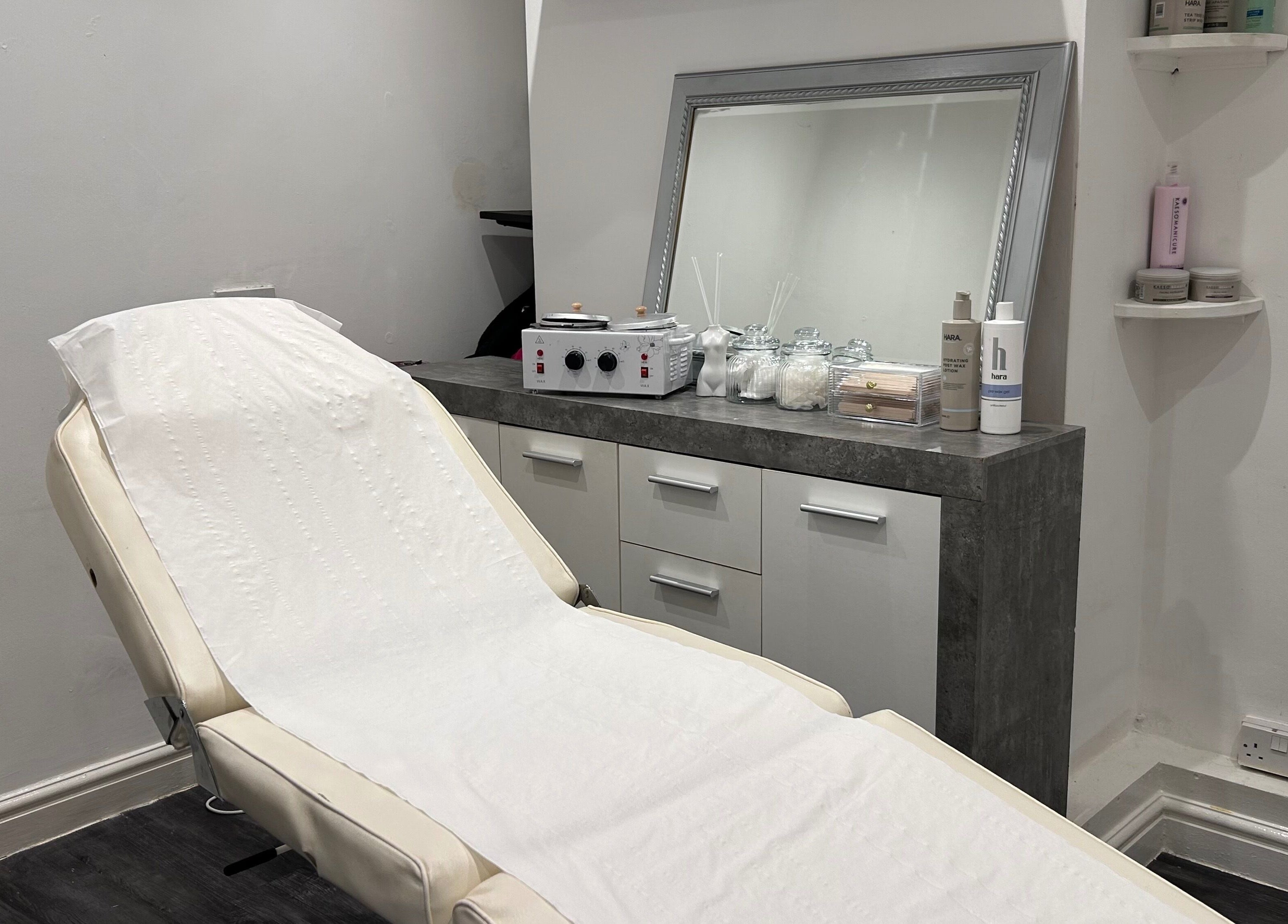 A tranquil treatment room at Beautiful You, Birmingham, England, GB, featuring a plush reclining chair and elegant decor.