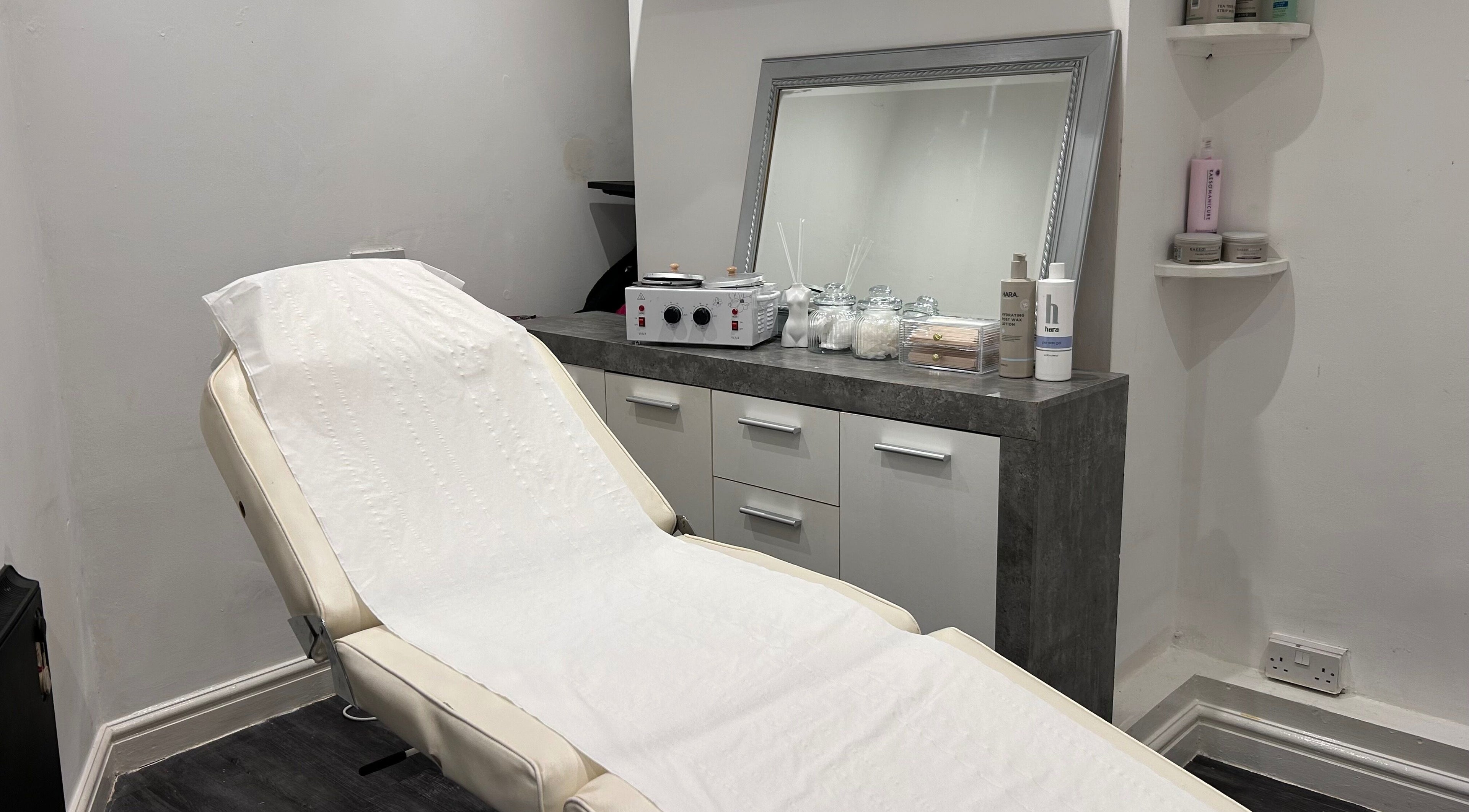 A tranquil treatment room at Beautiful You, Birmingham, England, GB, featuring a plush reclining chair and elegant decor.