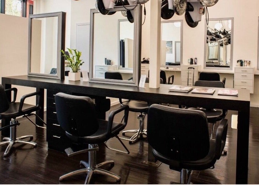 Modern styling area at K&S Salon, Albany, New York, US, with sleek chairs and mirrors.