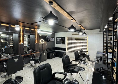 Stylish interior of Hairsurgery Lifestyle salon in Bloemfontein, Free State, ZA with modern decor and seating.