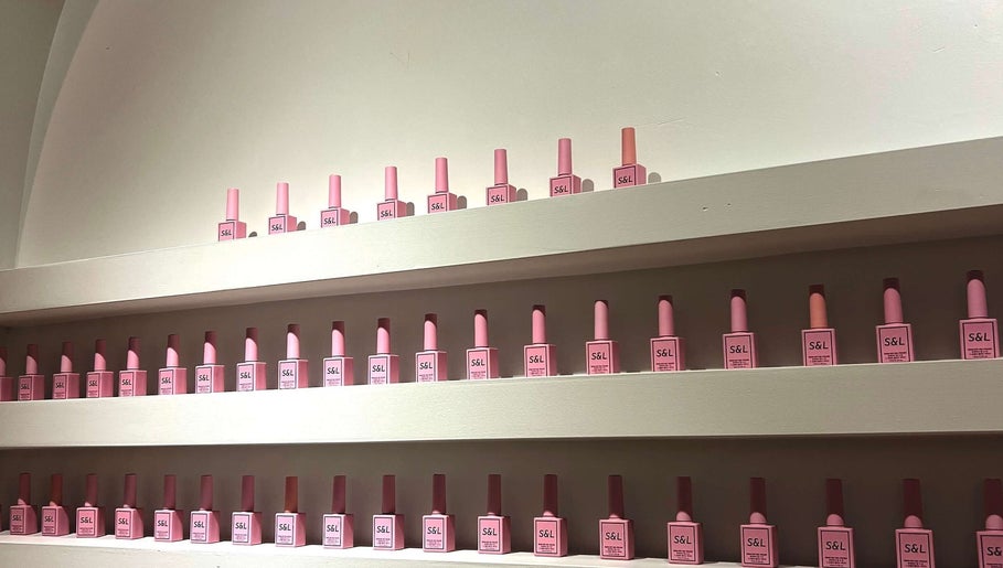 Neatly arranged pink nail polish bottles on shelves at Siara Nails, Paramaribo, Paramaribo, SR.