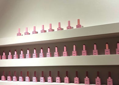 Neatly arranged pink nail polish bottles on shelves at Siara Nails, Paramaribo, Paramaribo, SR.