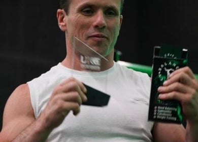 Athlete holding awards at Resalve LTD, Coventry, England, GB showcasing fitness excellence.