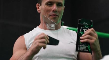 Athlete holding awards at Resalve LTD, Coventry, England, GB showcasing fitness excellence.