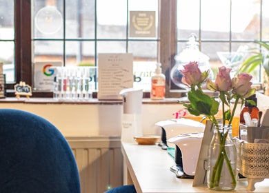 Flowers and beauty tools at Posh Nail and Beauty in Aston-on-trent, England, GB create a serene workspace.