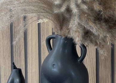 Elegant black vase with pampas grass at By Lottie Grace, Margate, England, GB.