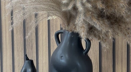 Elegant black vase with pampas grass at By Lottie Grace, Margate, England, GB.