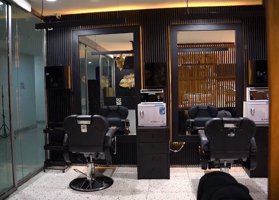 Modern salon interior at Mufasxclusivetouch, Abuja, Federal Capital Territory, NG showcasing luxury styling chairs.