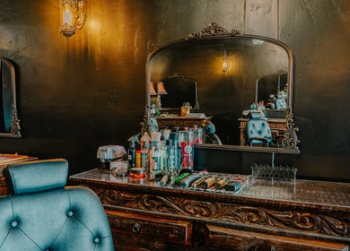 Elegant salon setup at Cut Republic Sedona, Sedona, Arizona, US with ornate mirror and styling tools.