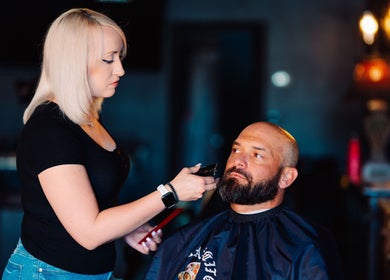 Professional barber grooming a client at Cut Republic Sedona, Sedona, Arizona, US, offering premium services.