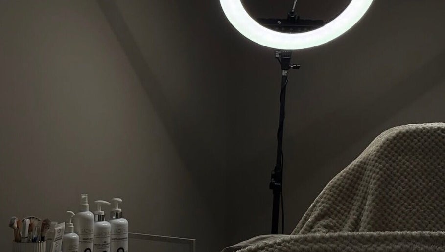Relaxing treatment room at WZAesthetics London featuring cozy bed and skincare products, London, England, GB.