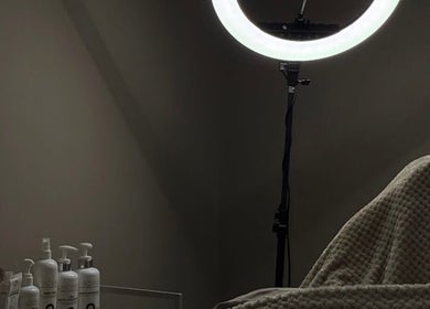 Relaxing treatment room at WZAesthetics London featuring cozy bed and skincare products, London, England, GB.