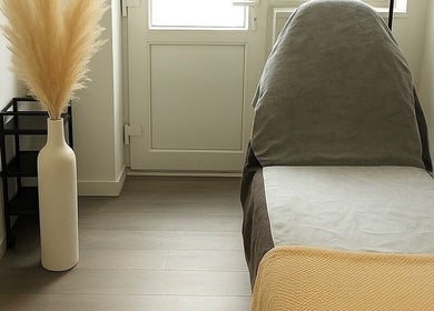 Comfortable treatment room at WZAesthetics London, London, England, GB with a plush bed and elegant decor.