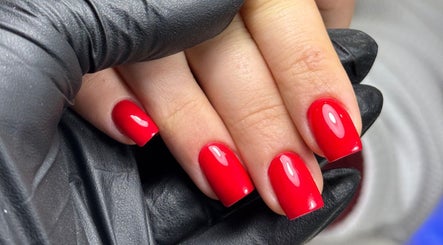 Vibrant red manicure done at Karas Beauty Hub in Montreal, Canada, CA. Perfectly polished nails.